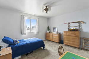 Bedroom featuring light carpet