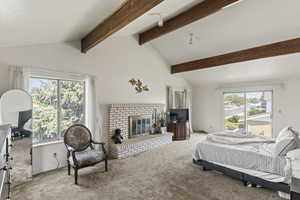 Bedroom with light carpet, a fireplace, and vaulted ceiling with beams