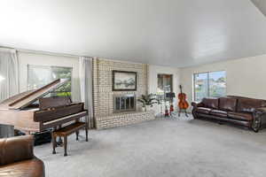 Living room featuring a fireplace and light colored carpet