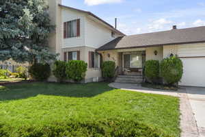 View of front of house featuring a garage and a front yard