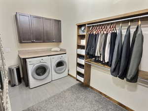 Main level master walk in closet with laundry and custom hardwood shelving