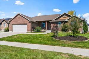 View of front of home with a front yard and a garage