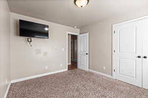 Unfurnished bedroom featuring carpet