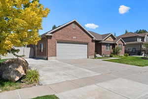 View of front of house with a garage and a front yard