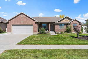 View of front of home featuring a garage and a front lawn