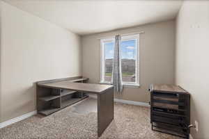 Office with light colored carpet and wine cooler