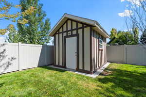 View of outbuilding with a yard