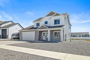 View of front of property with a garage and covered porch