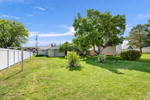 View of yard with a storage unit