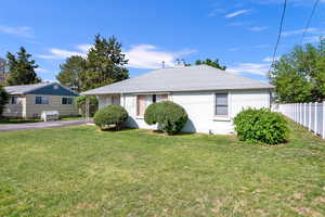 Ranch-style house with a patio area and a front lawn