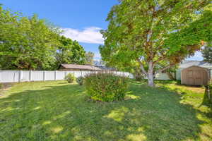 View of yard featuring a storage unit