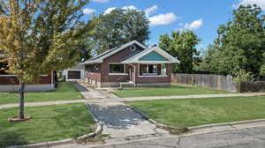 View of front of property featuring a garage and a front yard