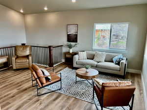 Living area with recessed lighting, light wood finished floors, and baseboards