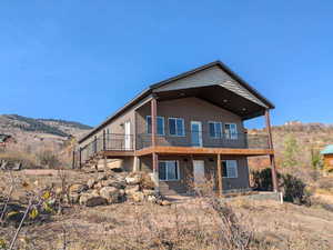 Rear view of house featuring a balcony