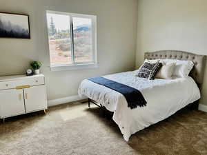 Bedroom with baseboards and carpet