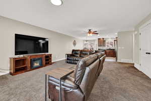 Living room featuring carpet flooring and ceiling fan