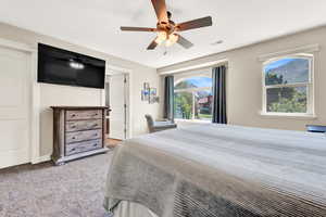 Carpeted bedroom with ceiling fan