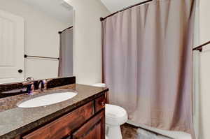 Full bathroom featuring vanity, toilet, and shower / bath combo