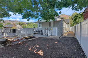 Back of property featuring a deck with mountain view