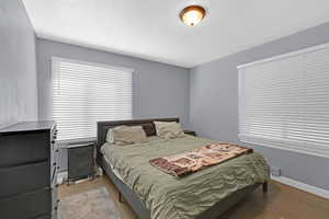 Bedroom with a textured ceiling and light wood-type flooring