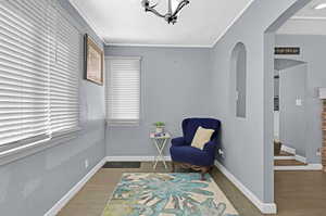 Sitting room featuring hardwood / wood-style floors and ornamental molding