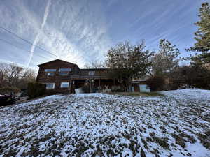 View of front of house featuring a wooden deck