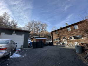 View of property exterior with an outbuilding and a garage