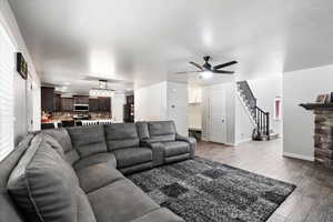 Living room featuring ceiling fan and light hardwood / wood-style flooring