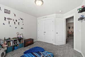 Bedroom with a closet and carpet floors