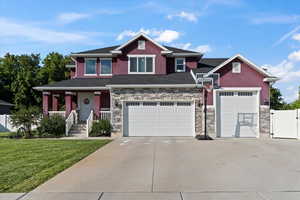 Craftsman-style home with covered porch and a front lawn