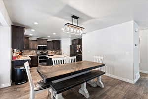 Dining area featuring dark hardwood / wood-style flooring and sink