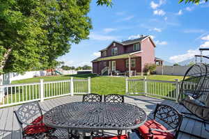 Wooden terrace featuring a yard