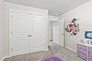 Bedroom featuring a closet and light carpet