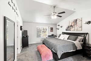 Bedroom with carpet flooring, ceiling fan, and vaulted ceiling