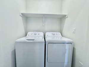 Washroom with washing machine and clothes dryer