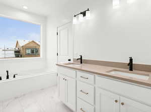 Bathroom with a tub and vanity