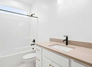 Full bathroom featuring vanity, toilet, and washtub / shower combination