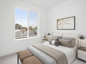 Carpeted bedroom featuring multiple windows