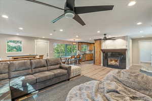 Living room featuring light wood-type flooring and ceiling fan