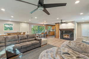 Living room with ceiling fan and hardwood / wood-style floors