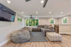 Living room with hardwood / wood-style flooring and ceiling fan