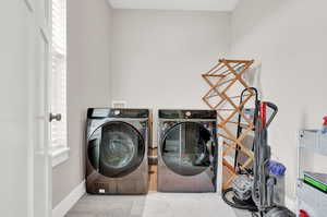 Washroom featuring independent washer and dryer