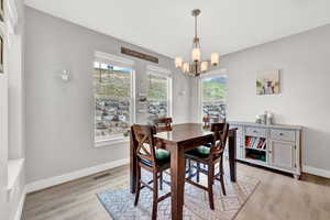 Dining room featuring a chandelier and light hardwood / wood-style floors