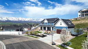 View of front of home with a garage and a mountain view