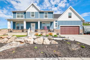 Craftsman-style home featuring a garage and covered porch