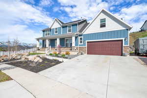 Craftsman house featuring a mountain view, a garage, and a porch