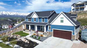 View of front of property with a mountain view, a garage, and covered porch