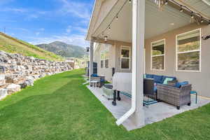 View of yard with outdoor lounge area, a mountain view, and a patio