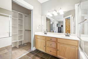 Bathroom featuring a textured ceiling and vanity