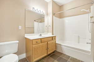 Full bathroom with vanity, toilet, and shower / tub combination